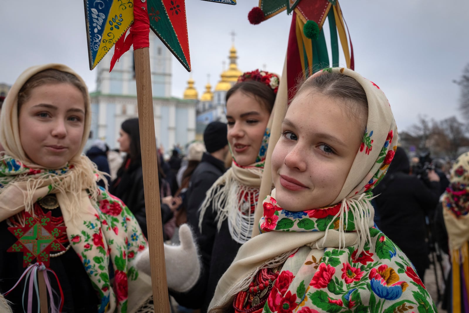 Girls in national costumes celebrate Christmas near St. Michael Monastery in a city centre in Kyiv, Ukraine, Wednesday, Dec. 25, 2024. (AP Photo/Efrem Lukatsky)