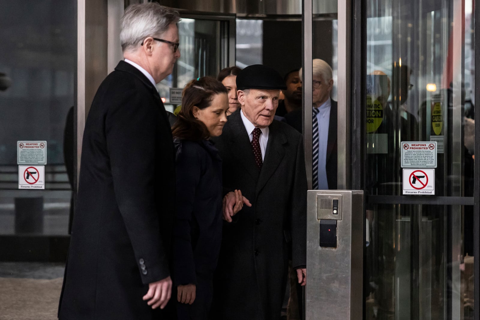 Flanked by supporters and holding hands with his daughter Nicole, Illinois' former House Speaker Michael Madigan walks out of the Dirksen Federal Courthouse in Chicago, Wednesday, Feb. 12, 2025. (Ashlee Rezin/Chicago Sun-Times via AP)