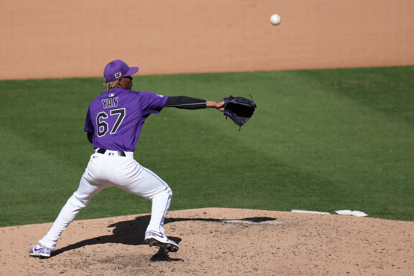 Colorado Rockies pitcher Jefry Yan tries to make a play on an infield ground ball hit by Seattle Mariners' Colt Emerson during the seventh inning of a spring training baseball game Sunday, March 2, 2025, in Scottsdale, Ariz. (AP Photo/Ross D. Franklin)