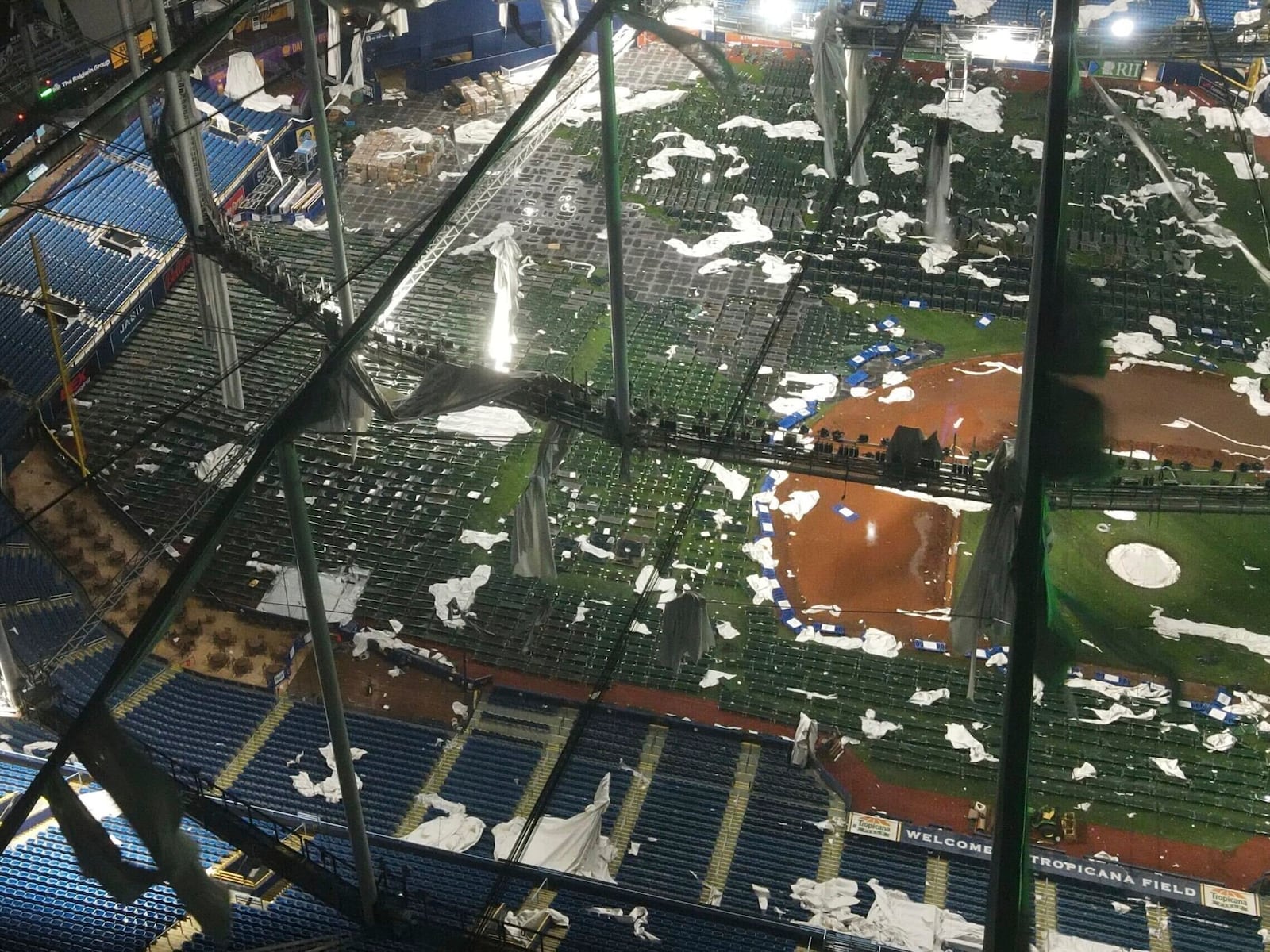 Drone images above Tropicana Field, home of the Tampa Bay Rays, show the shredded roof of the dome and the cots on the field, set up for first responders, among the debris, Thursday, Oct. 10, 2024 in St. Petersburg, Fla. (Max Chesnes/Tampa Bay Times via AP)