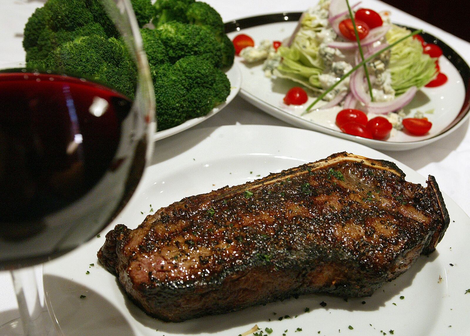 Photo of the Prime Bone-In New York Strip steak with fresh Broccoli and the Wedges salad.  (PHOTO BY PHIL SKINNER /staff)