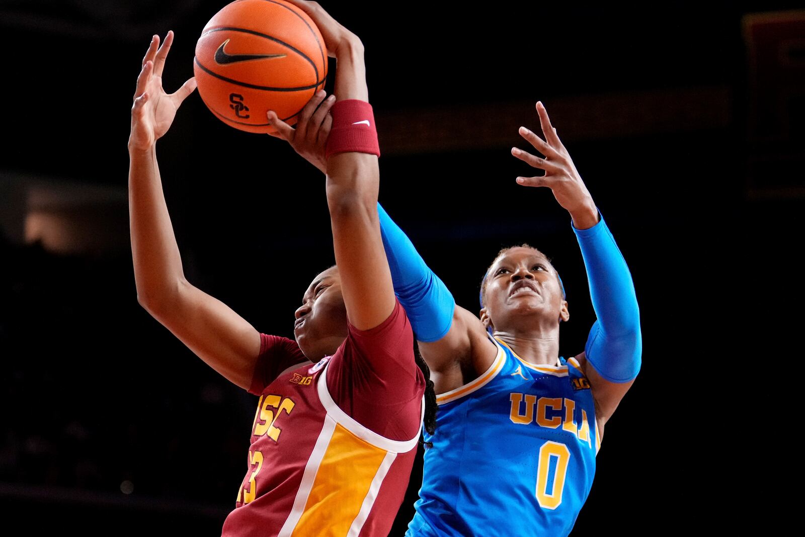 Southern California center Rayah Marshall, left, and UCLA forward Janiah Barker reach for a rebound during the first half of an NCAA college basketball game, Thursday, Feb. 13, 2025, in Los Angeles. (AP Photo/Mark J. Terrill)