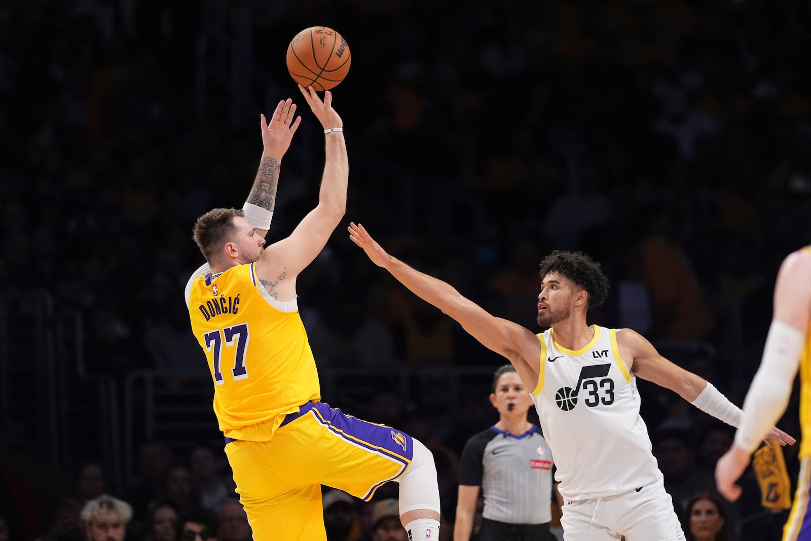 Los Angeles Lakers guard Luka Doncic (77) shoots as Utah Jazz guard Johnny Juzang defends during the first half of an NBA basketball game, Monday, Feb. 10, 2025, in Los Angeles. (AP Photo/Mark J. Terrill)