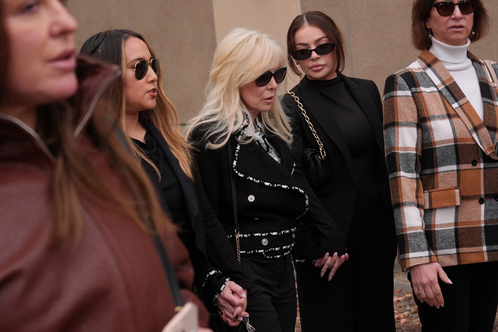 Tammi Menendez, center, the wife of Eric Menendez, leaves a courthouse after a hearing in Los Angeles, Monday, Nov. 25, 2024. (AP Photo/Jae C. Hong)