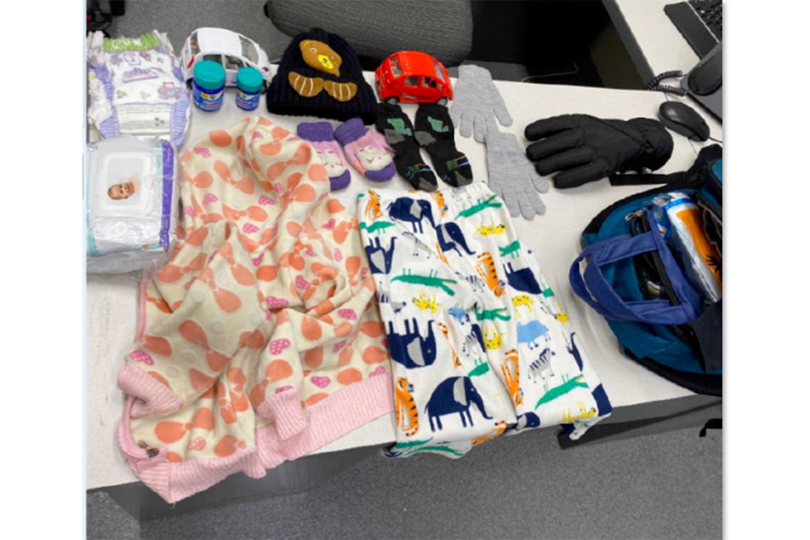 In an undated image released by the U.S. Attorney’s Office, shows items found in a migrant child’s backpack. (U.S. Attorney's Office via AP)