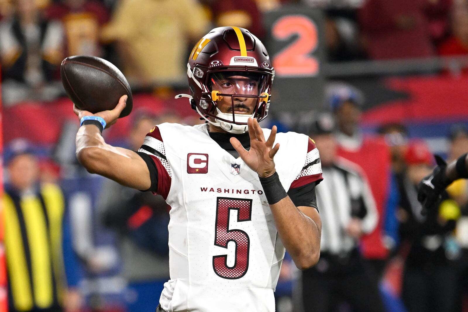 Washington Commanders quarterback Jayden Daniels (5) passes against the Tampa Bay Buccaneers during the first half of an NFL wild-card playoff football game in Tampa, Fla., Sunday, Jan. 12, 2025. (AP Photo/Jason Behnken)