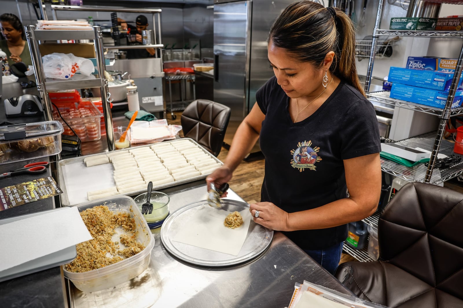 Catherine Roberts, owner of The Lumpia Queen makes lumpia at W. Social Tap & Table. JIM NOELKER/STAFF