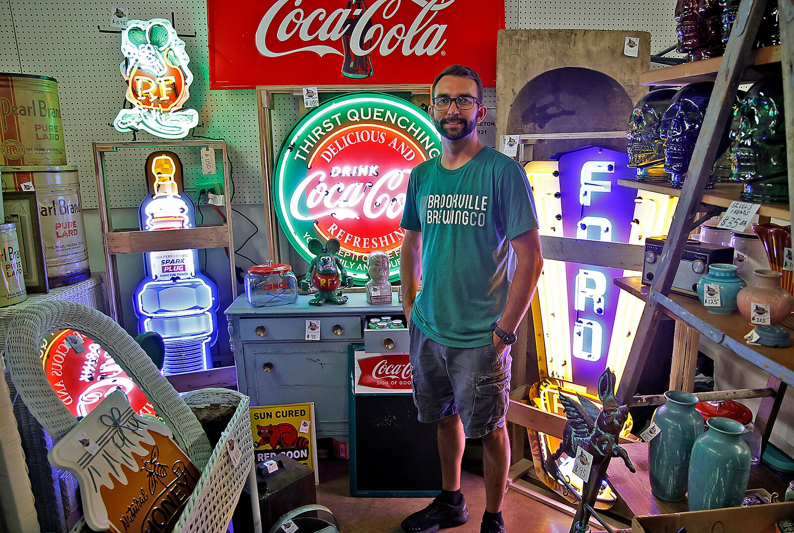 Russell Singleton is surrounded by neon in his booth at the Springfield Antique Show & Flea Market Extravaganza at the Clark County Fairgrounds Friday, Sept. 15, 2023. The Extravaganza runs through Sunday from 8:00 a.m. - 6:00pm and features over 2000 antique, vintage and flea market dealers. BILL LACKEY/STAFF