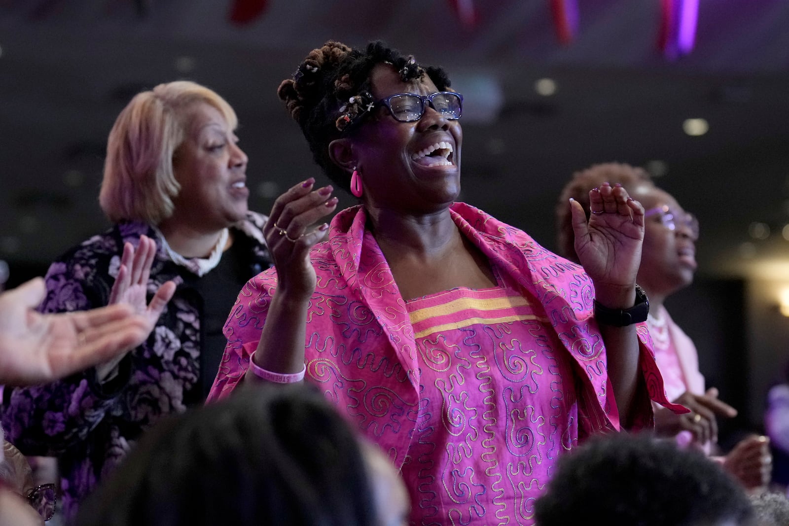 Attendees sing during a service at New Birth Baptist Church before democratic presidential nominee Vice President Kamala Harris speaks, in Stonecrest, Ga., Sunday, Oct. 20, 2024. (AP Photo/Jacquelyn Martin)