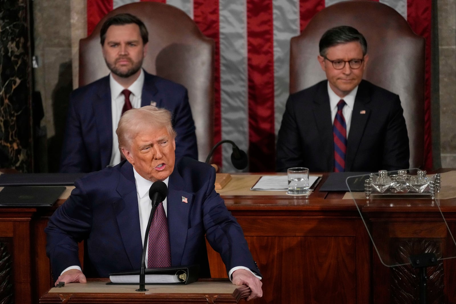 President Donald Trump addresses a joint session of Congress in the House chamber at the U.S. Capitol in Washington, Tuesday, March 4, 2025, as Vice President JD Vance and House Speaker Mike Johnson of La., listen. (AP Photo/Julia Demaree Nikhinson)