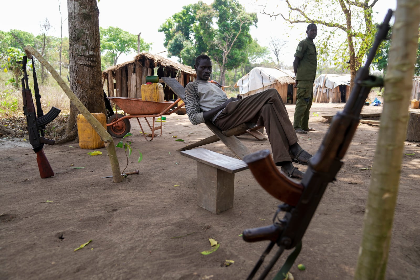 Soldiers sit at their outpost near Nzara, South Sudan on Saturday, Feb. 15, 2025. (AP Photo/Brian Inganga)