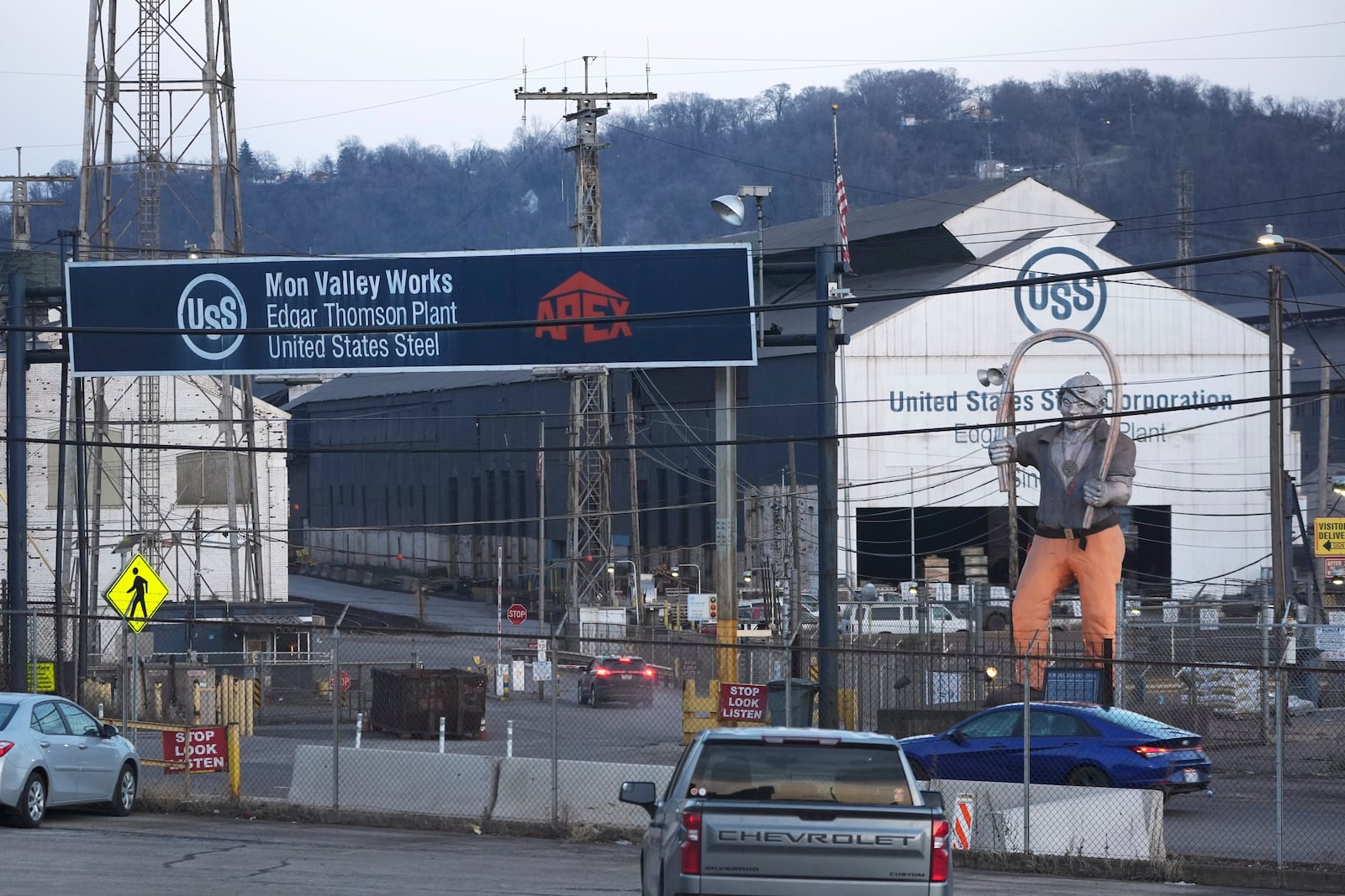 Cars sit parked outside the United States Steel Corporations Edgar Thomson Plant in Braddock, Pa., on Tuesday, March 4, 2025, in Braddock, Pa. (AP Photo/Gene J. Puskar)