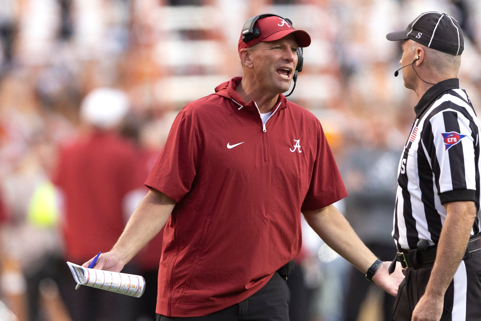 Alabama head coach Kalen DeBoer pleads with side judge Ryan Flynn after a penalty was called during the second half of an NCAA college football game against Tennessee, Saturday, Oct. 19, 2024, in Knoxville, Tenn. (AP Photo/Wade Payne)