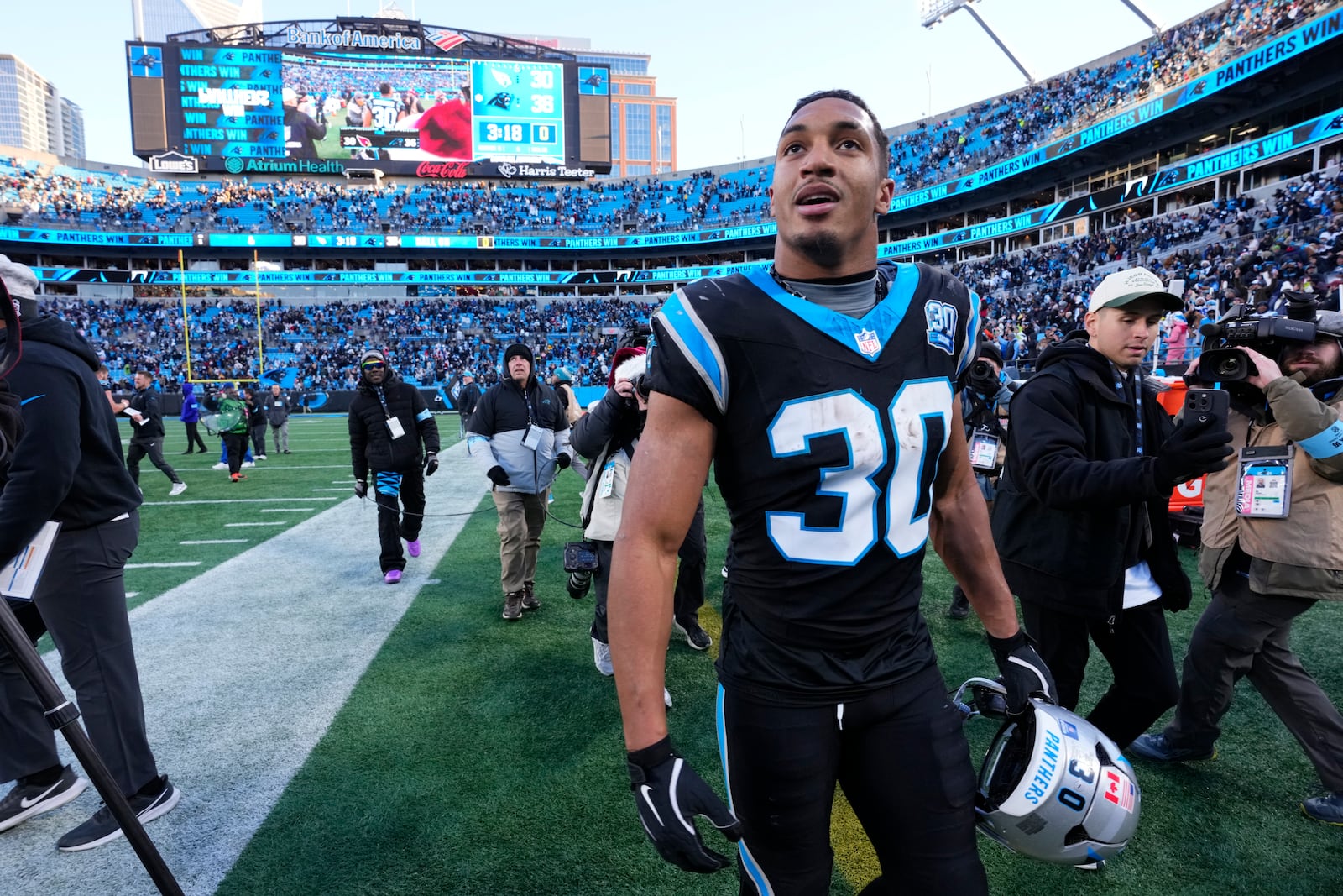 Carolina Panthers running back Chuba Hubbard leaves the field after scoring the winning touchdown against the Arizona Cardinals during overtime of an NFL football game, Sunday, Dec. 22, 2024, in Charlotte, N.C. (AP Photo/Rusty Jones)