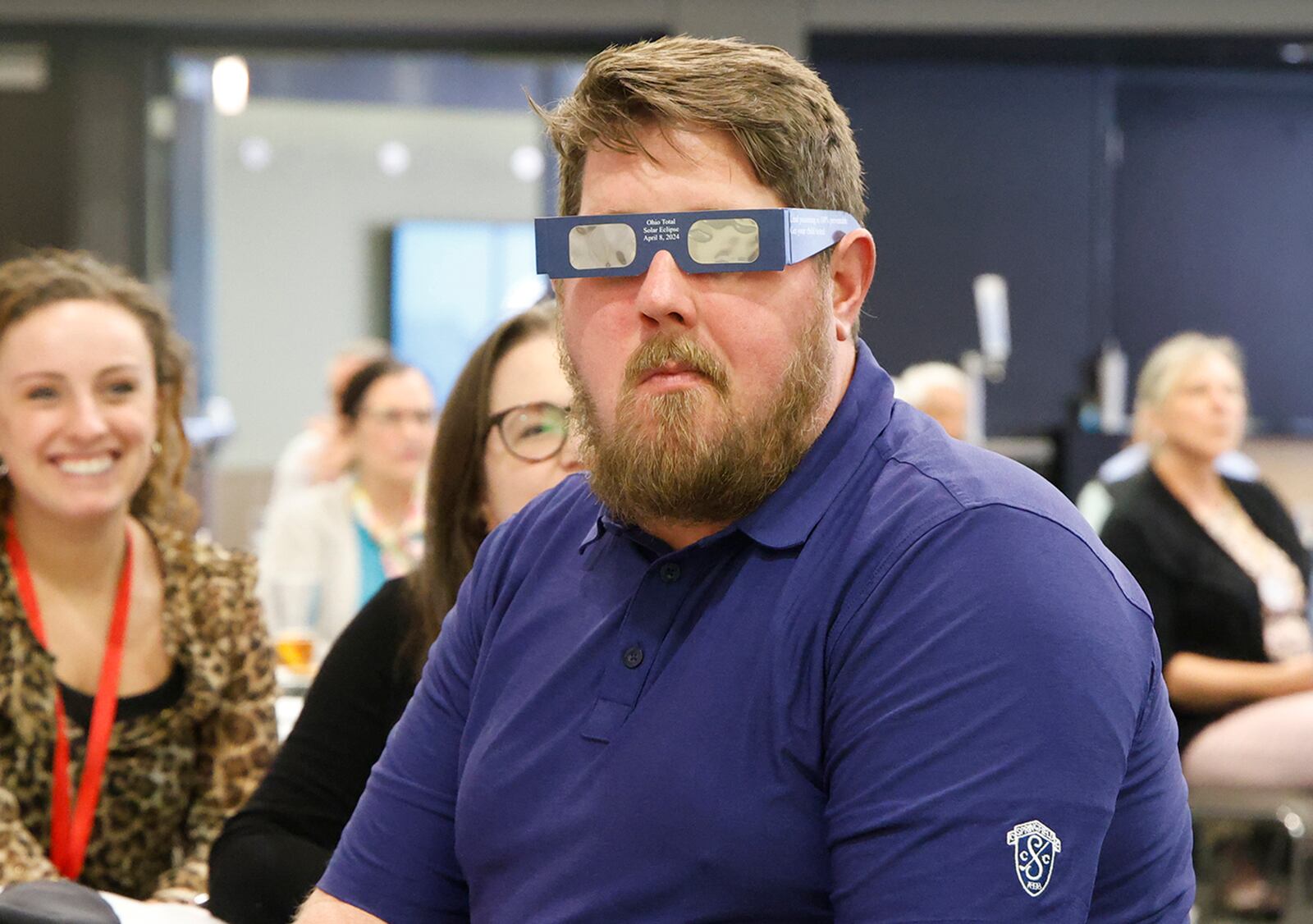 Zach McPherson, a guest at Monday's weekly Springfield Rotary Club meeting, tries on the solar eclipse glasses that he and everyone else received from the Clark County Combined Health District. Stephanie Johnson, from the Health District, talked to Rotary members and their guests about the upcoming solar eclipse and the importance of wearing eclipse glasses to protect your eyes Monday, March 4, 2024. BILL LACKEY/STAFF