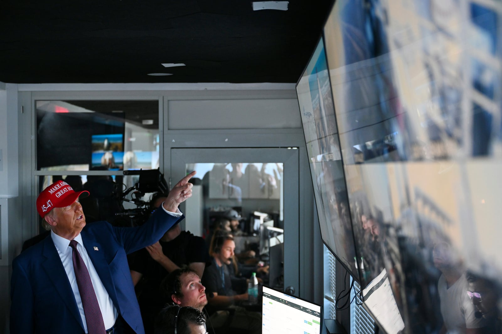 President-elect Donald Trump speaks as Elon Musk explains the operations in the control room ahead of the launch of the sixth test flight of the SpaceX Starship rocket Tuesday, Nov. 19, 2024 in Brownsville, Texas. (Brandon Bell/Pool via AP)