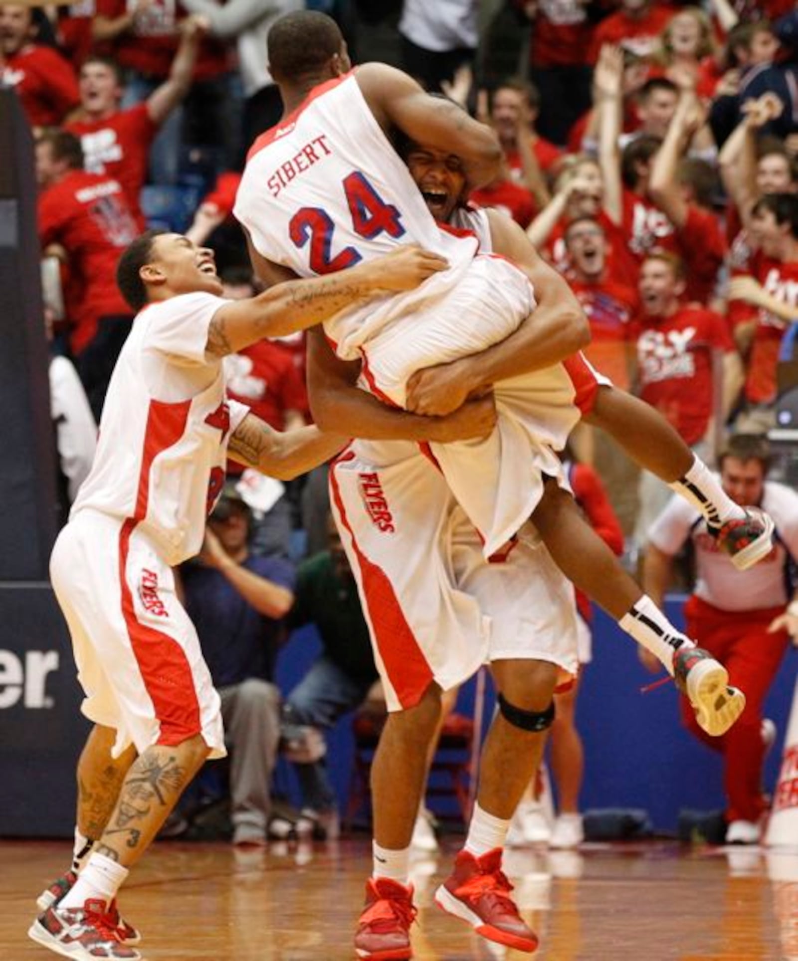 Devin Oliver picks up Jordan Sibert after Sibert's game-winning 3-pointer with 1 second left against IPFW on Saturday, Nov. 9, 2013, at UD Arena. Guard Kyle Davis is at left.