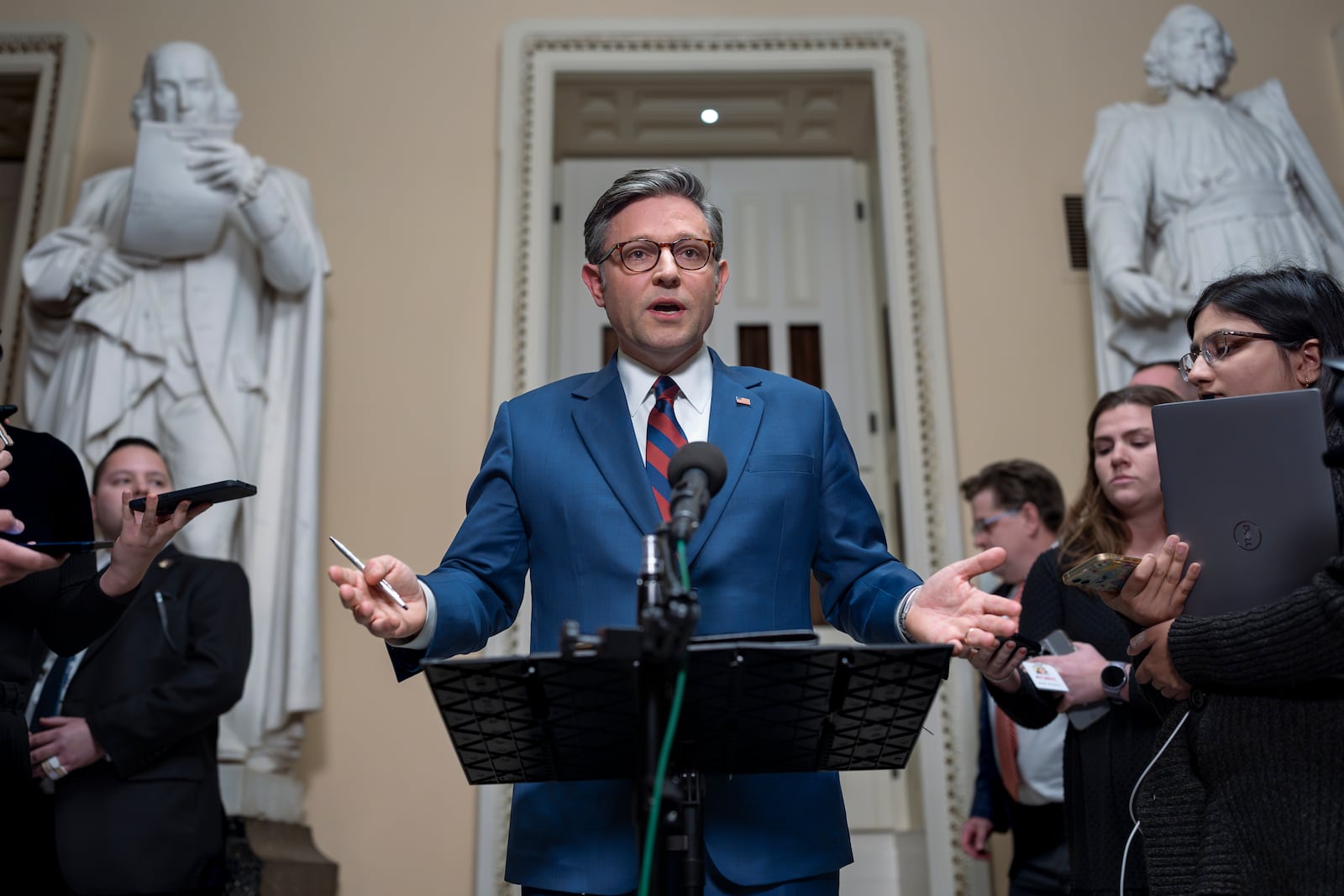 Speaker of the House Mike Johnson, R-La., talks briefly to reporters just before a vote on an amended interim spending bill to prevent a government shutdown, at the Capitol in Washington, Thursday, Dec. 19, 2024. (AP Photo/J. Scott Applewhite)