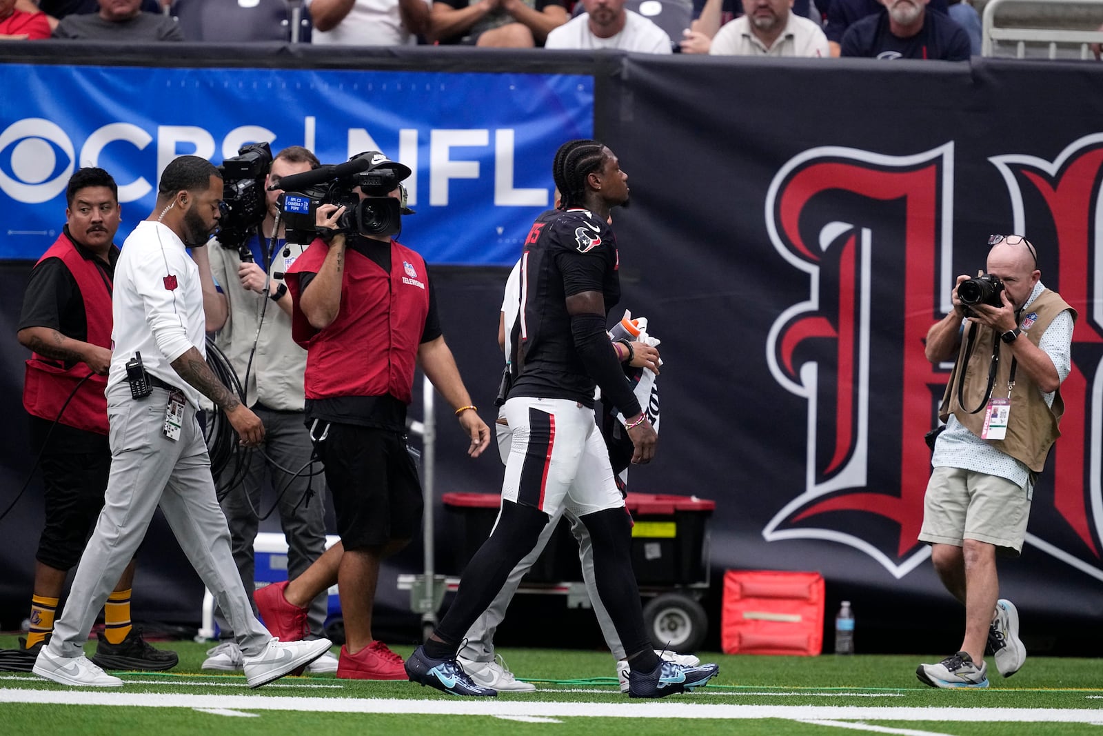 Houston Texans wide receiver Stefon Diggs (1) walks off the field after getting injured during the second half of an NFL football game against the Indianapolis Colts, Sunday, Oct. 27, 2024, in Houston. (AP Photo/Tony Gutierrez)