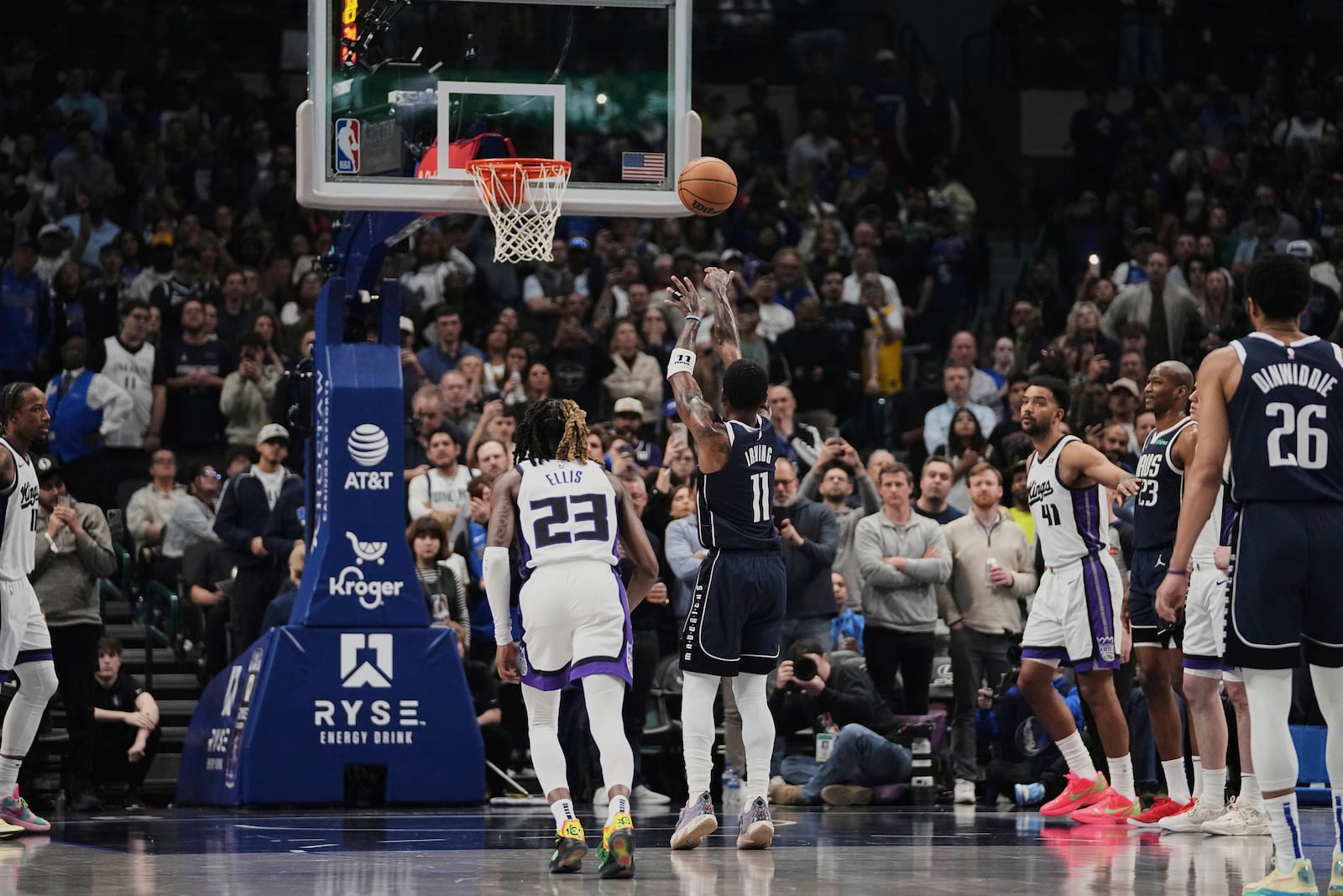 Dallas Mavericks guard Kyrie Irving (11) shoots free throws as Sacramento Kings guard Keon Ellis (23) looks on after Irving suffered an unknown injury and left the game in the first half of an NBA basketball game in Dallas, Monday, March 3, 2025. (AP Photo/Tony Gutierrez)