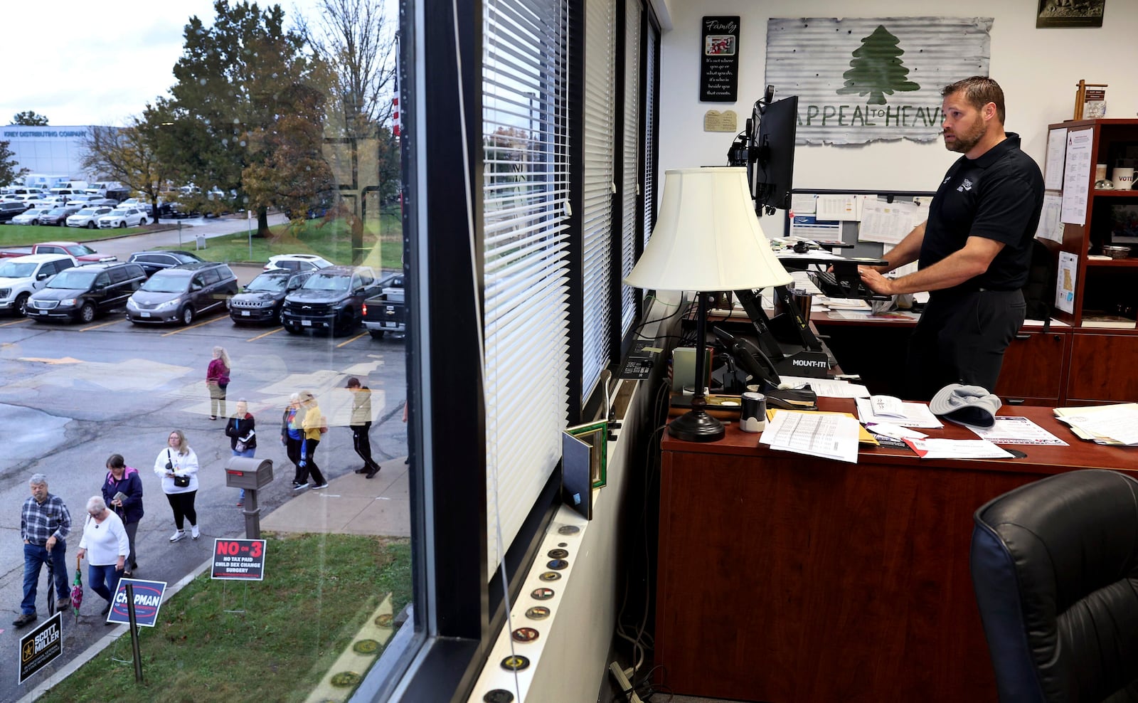 A line of early voters wraps around the election authority offices as St. Charles County Elections Director Kurt Bahr works in his office on Thursday, Oct. 31, 2024 in St. Peters, Mo. (Robert Cohen/St. Louis Post-Dispatch via AP)