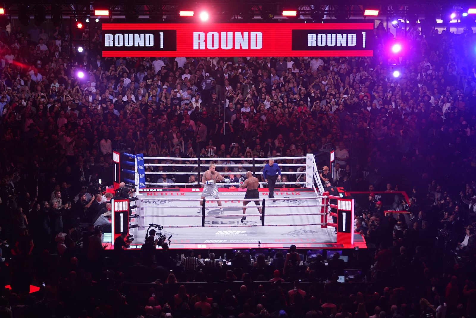 Jake Paul, left, and Mike Tyson fight during their heavyweight boxing match, Friday, Nov. 15, 2024, in Arlington, Texas. (AP Photo/Julio Cortez)