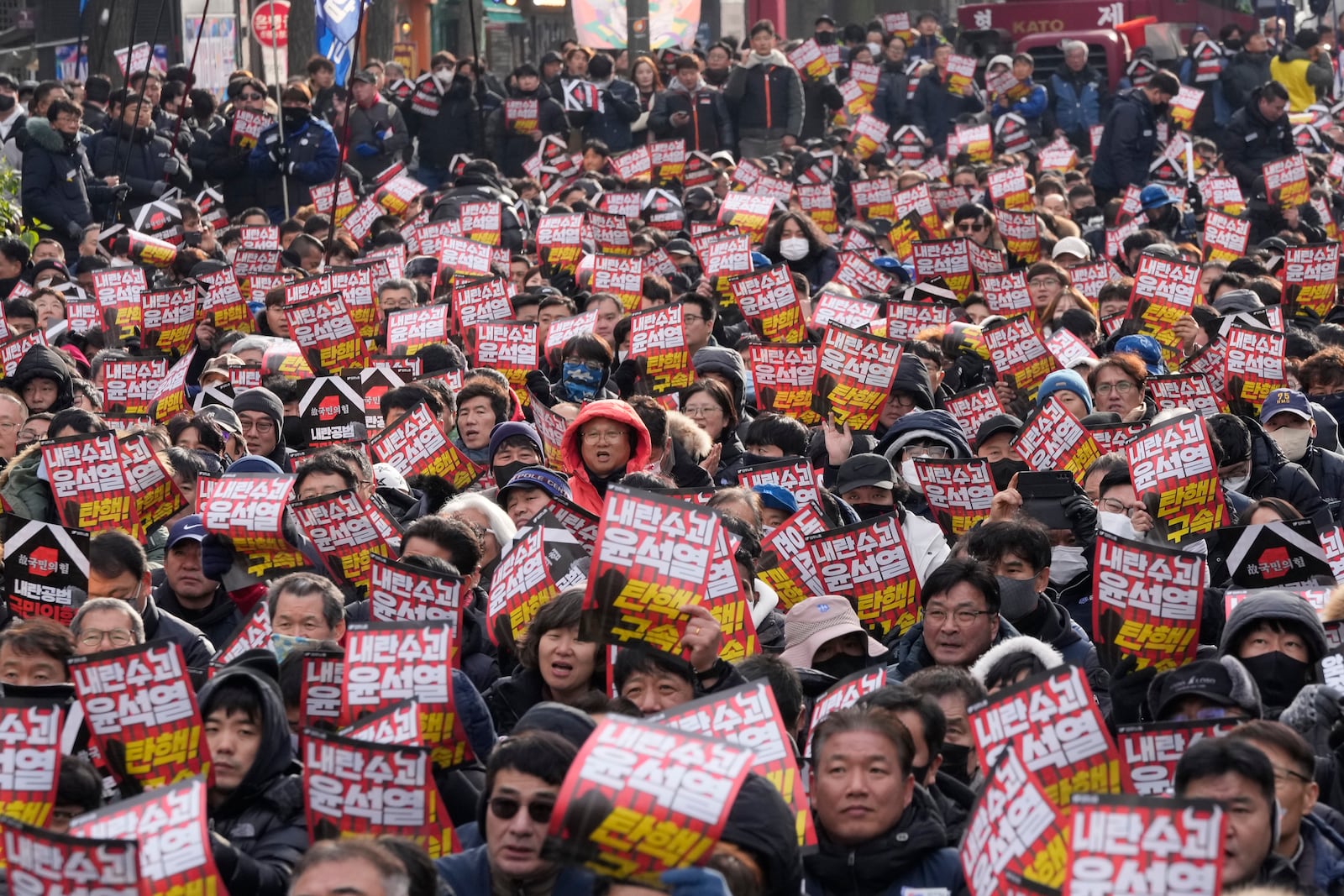 Protesters stage a rally to demand South Korean President Yoon Suk Yeol's impeachment in Seoul, South Korea, Thursday, Dec. 12, 2024. The signs read "Arrest the rebellion leader Yoon Suk Yeol." (AP Photo/Ahn Young-joon)