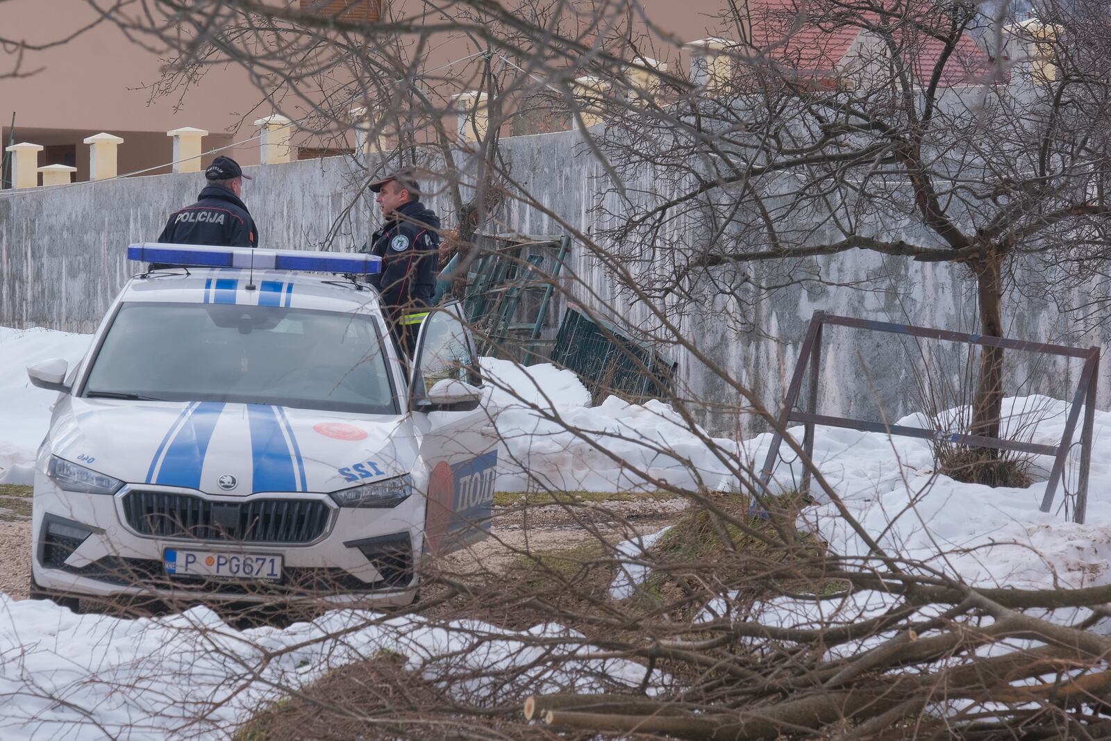 Police officers stand guard at the home of a gunman after a shooting incident, in Cetinje, 36 kilometers (22 miles) west of Podogrica, Montenegro, Thursday, Jan. 2, 2025. (AP Photo/Risto Bozovic)