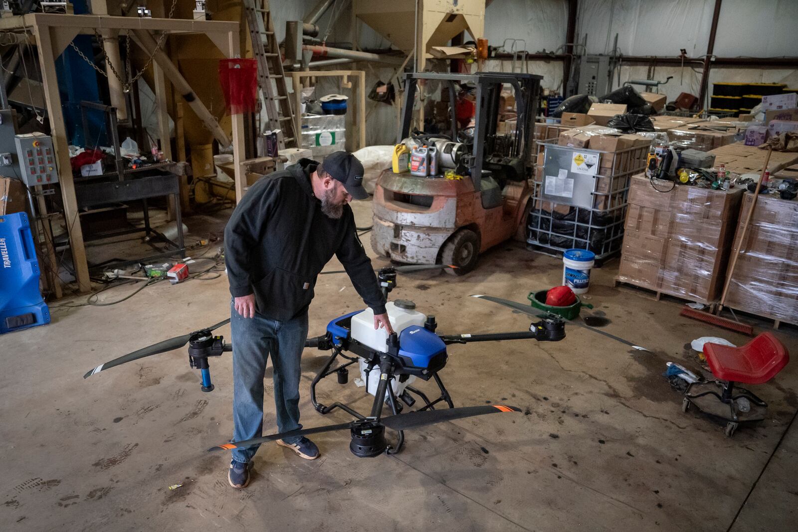 Russell Hedrick pulls out an EA Vision drone on his farm, Tuesday, Dec. 17, 2024, in Hickory, N.C. (AP Photo/Allison Joyce)