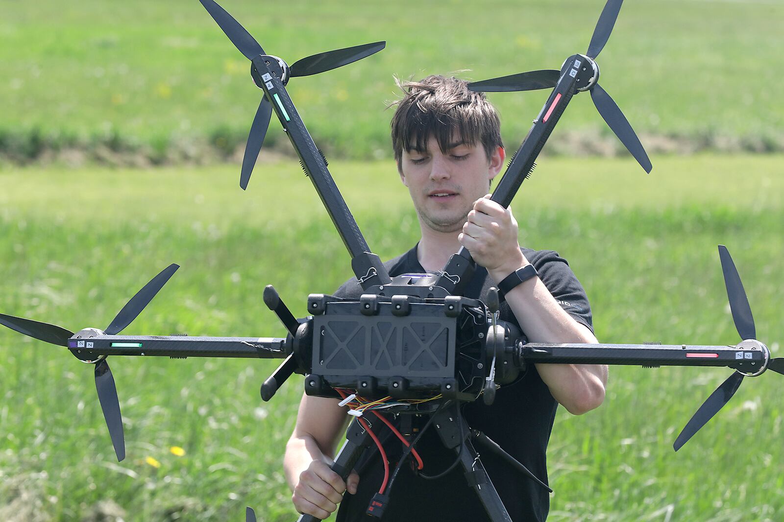 Gus Meyer, a drone pilot at SIC Drones, calibrates one of the company's UAV's at the Springfield Beckley Municipal Airport. BILL LACKEY/STAFF