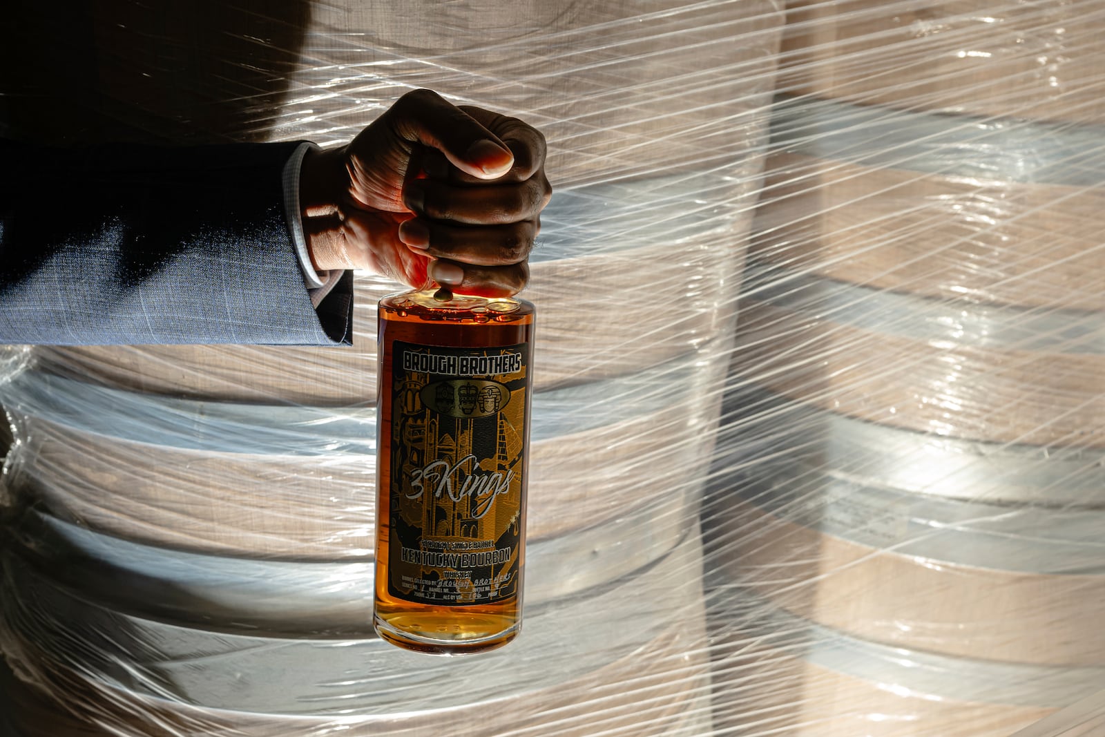 Victor Yarbrough, CEO of Brough Brothers Distillery holds of bottle of the company's product in Louisville, Ky., Saturday, March 8, 2025. (AP Photo/Jon Cherry)