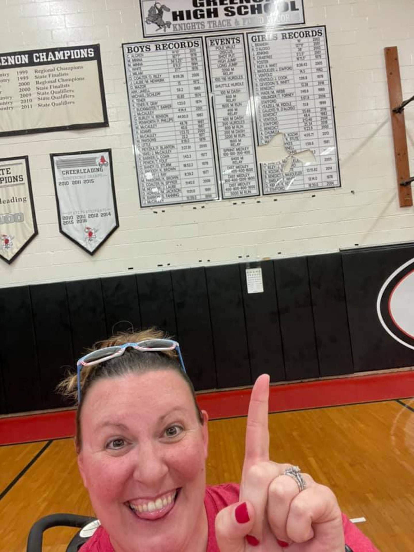 Stacie McConehea points to her name and high jump record at Greenon High School. Submitted photo