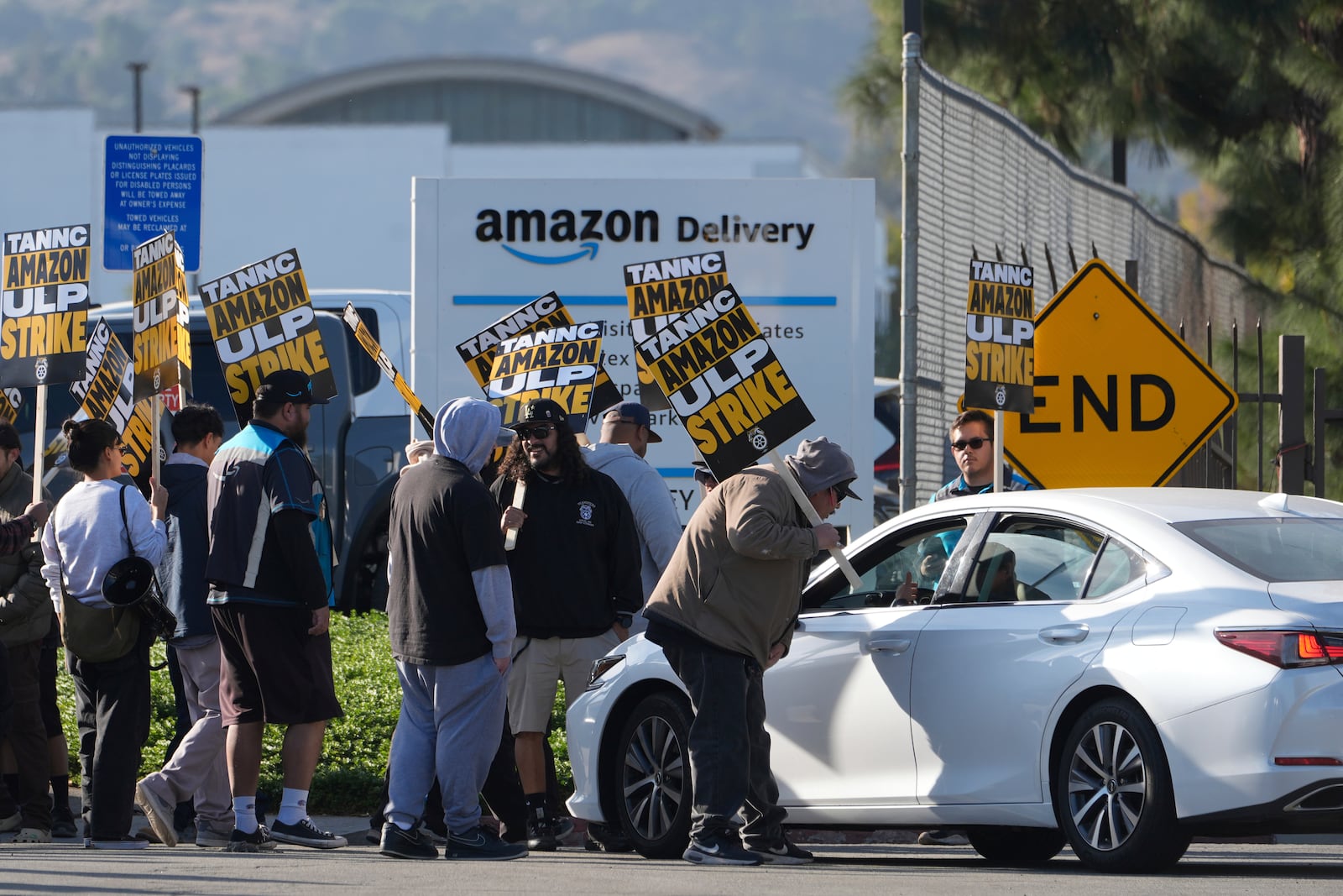 Amazon workers, on strike, picket outside an Amazon Fulfillment Center, Thursday, Dec. 19, 2024, in City of Industry, Calif. (AP Photo/Damian Dovarganes)