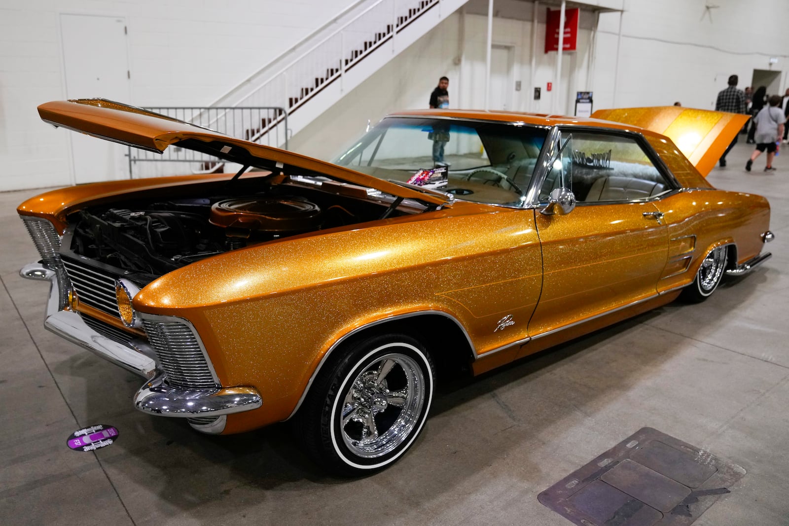 A gold lowrider car is on display at the Slow & Low Chicago Lowrider Festival, Saturday, Oct. 12, 2024, at Navy Pier in Chicago. (AP Photo/Erin Hooley)