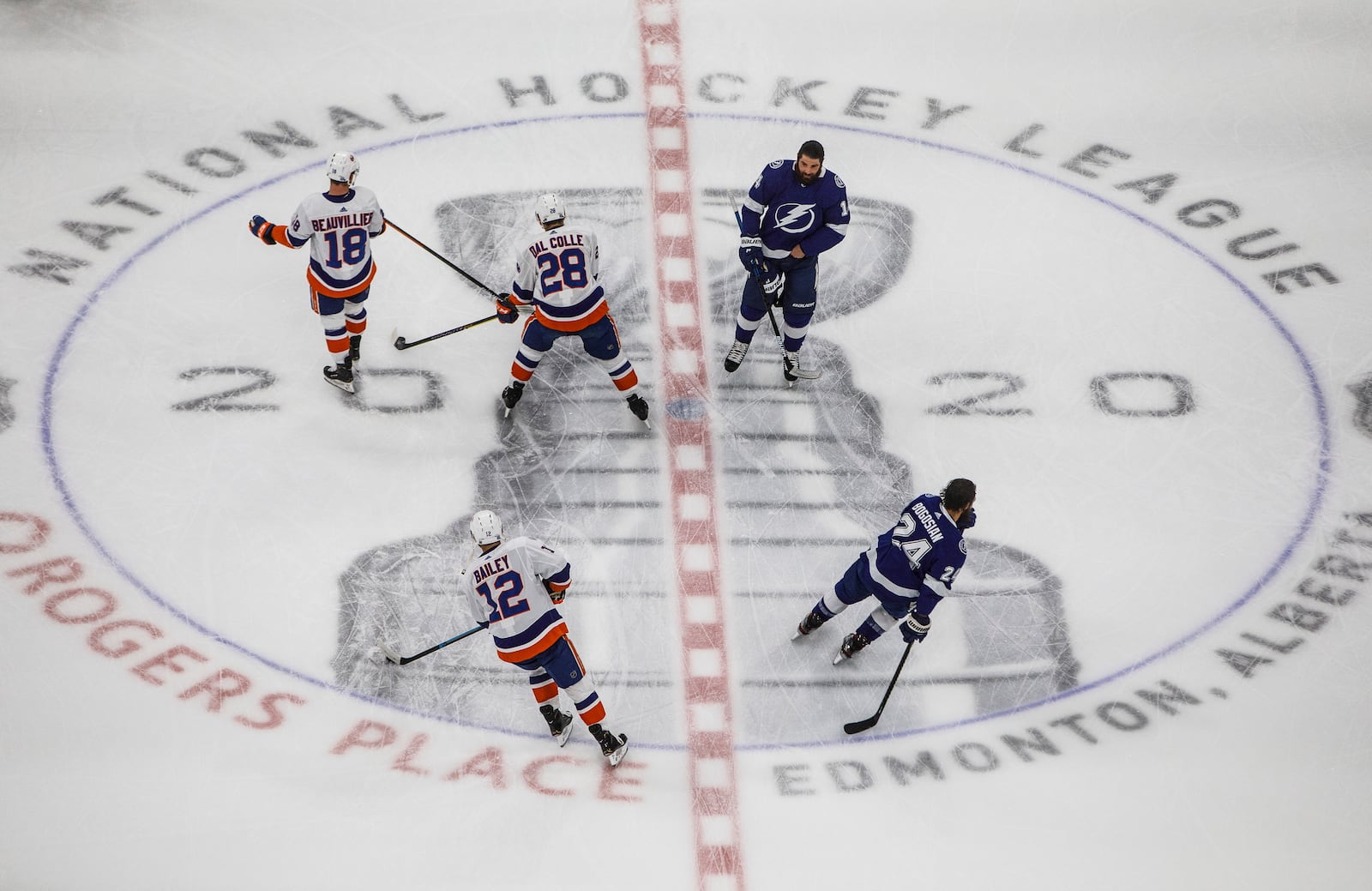 Tampa Bay Lightning's Pat Maroon (14) and teammate Zach Bogosian (24) skate during warm up alongside New York Islanders' Anthony Beauvillier (18) and teammates Michael Dal Colle (28) and Josh Bailey (12) before the first period of an NHL Eastern Conference final playoff game, Monday, Sept. 7, 2020, in Edmonton, Alberta. (Jason Franson/The Canadian Press via AP)