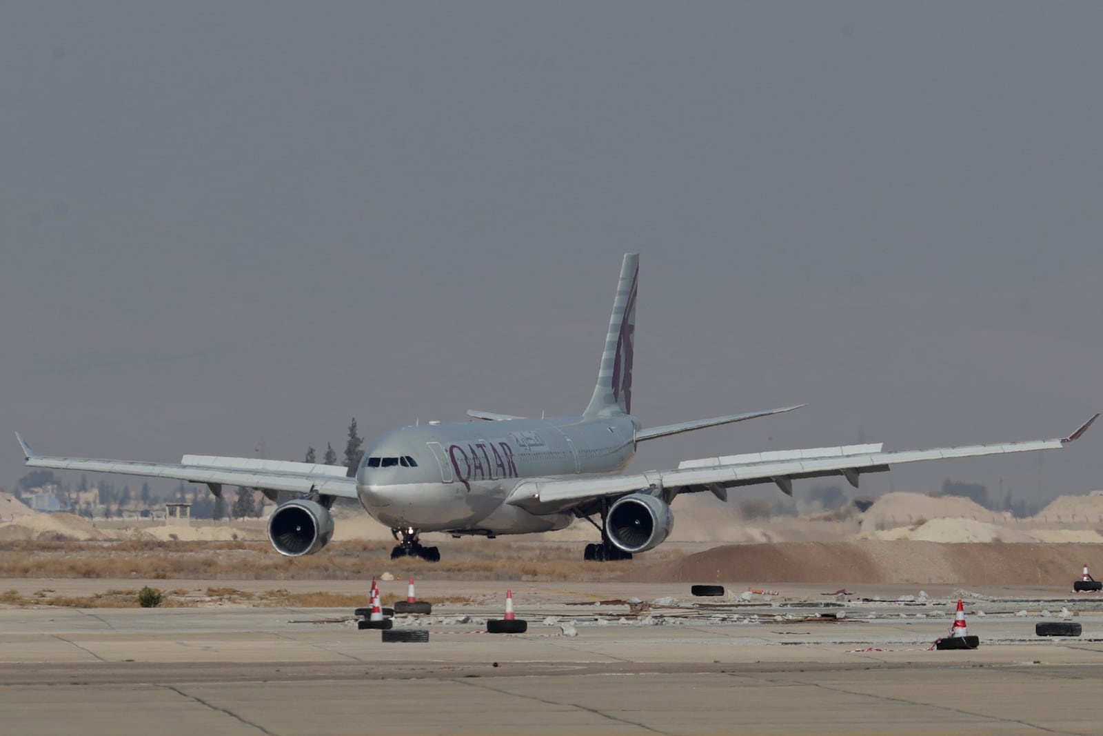 Qatar Airways plane a first international commercial flight since the fall of former Syrian President Bashar Assad, landing at Damascus international airport arriving from Qatar, in Damascus, Syria, Tuesday, Jan. 7, 2025. (AP Photo/Omar Sanadiki)