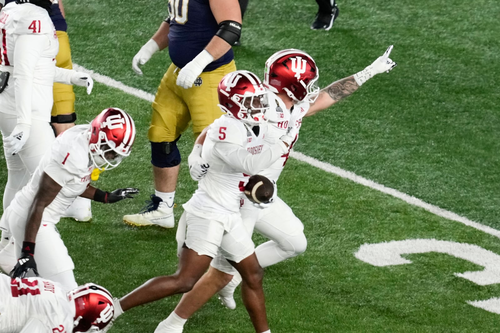 Indiana defensive back D'Angelo Ponds (5) celebrates his interception of a Notre Dame quarterback Riley Leonard pass during the first half in the first round of the NCAA College Football Playoff, Friday, Dec. 20, 2024, in South Bend, Ind. (AP Photo/Darron Cummings)