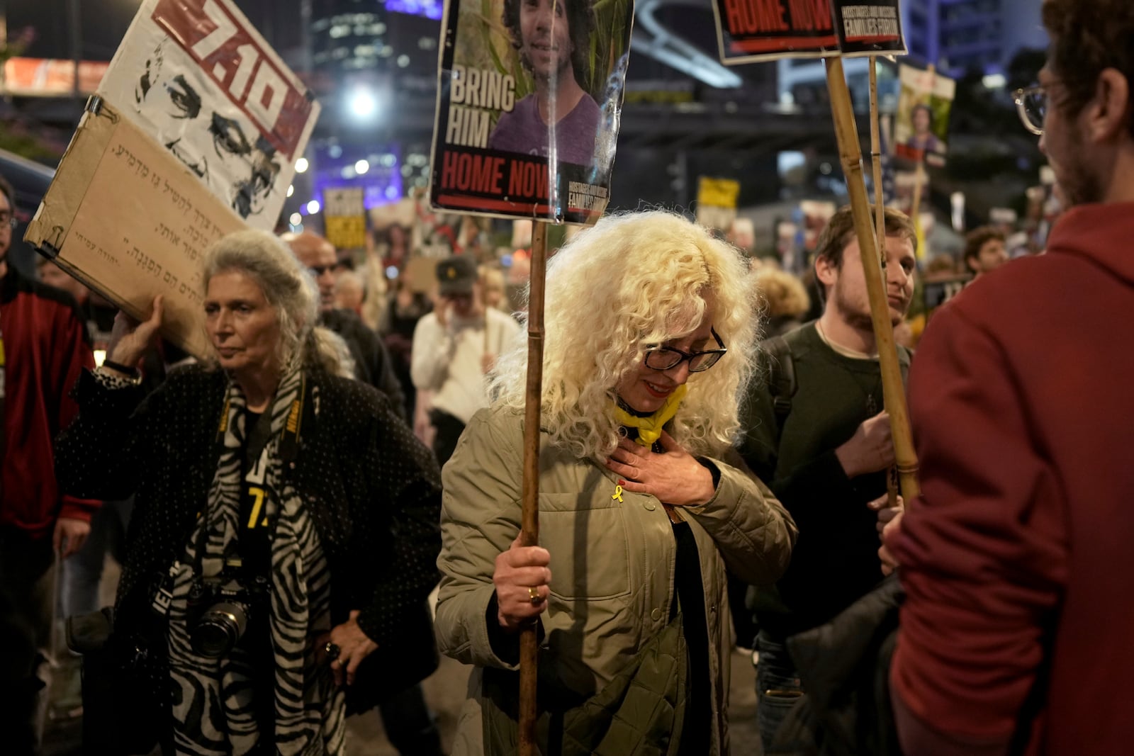 Relatives and friends of people killed and abducted by Hamas and taken into Gaza, take part in a demonstration in Tel Aviv, Israel, Wednesday, Jan. 15, 2025. (AP Photo/Oded Balilty)