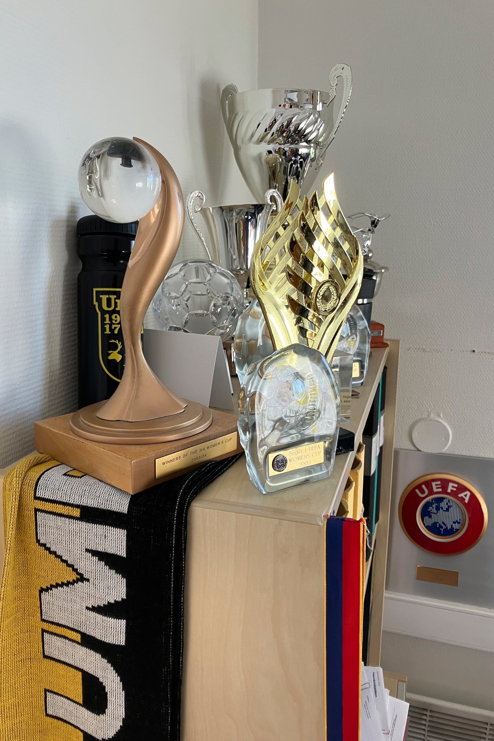 The 2003 and 2004 UEFA Women's Cup trophies rest on a shelf inside the offices of Umeå IK soccer team, next to Umeå Energi Arena in Umeå, Sweden, Monday, March 10, 2025. (AP Photo/Steve Douglas)