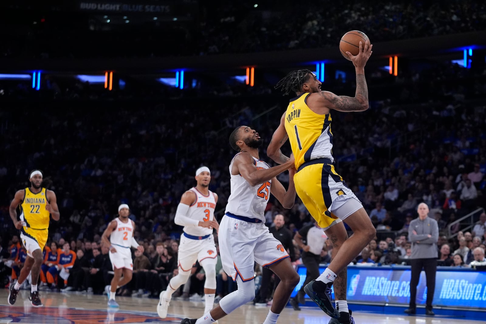 Indiana Pacers' Obi Toppin (1) drives past New York Knicks' Mikal Bridges (25) during the first half of an NBA basketball game Friday, Oct. 25, 2024, in New York. (AP Photo/Frank Franklin II)