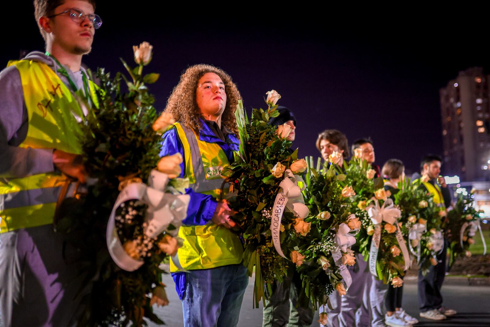 Youngsters carry wreaths with the names of victims during a protest over the collapse of a concrete canopy that killed 15 people more than two months ago, in Novi Sad, Serbia, Friday, Jan. 31, 2025. (AP Photo/Armin Durgut)