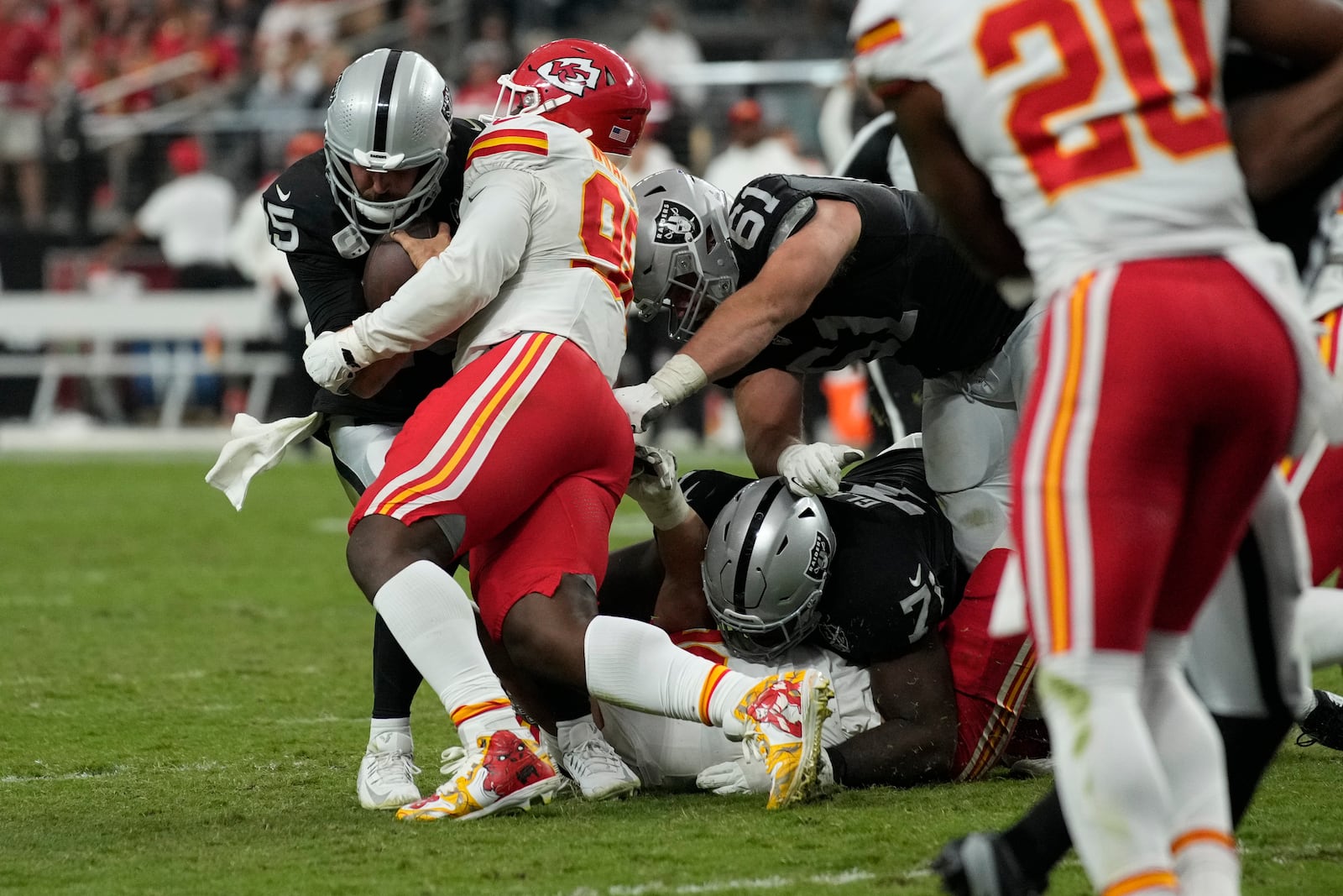 Las Vegas Raiders quarterback Gardner Minshew (15) is stopped by Kansas City Chiefs defensive tackle Tershawn Wharton (98) during the second half of an NFL football game Sunday, Oct. 27, 2024, in Las Vegas. (AP Photo/John Locher)