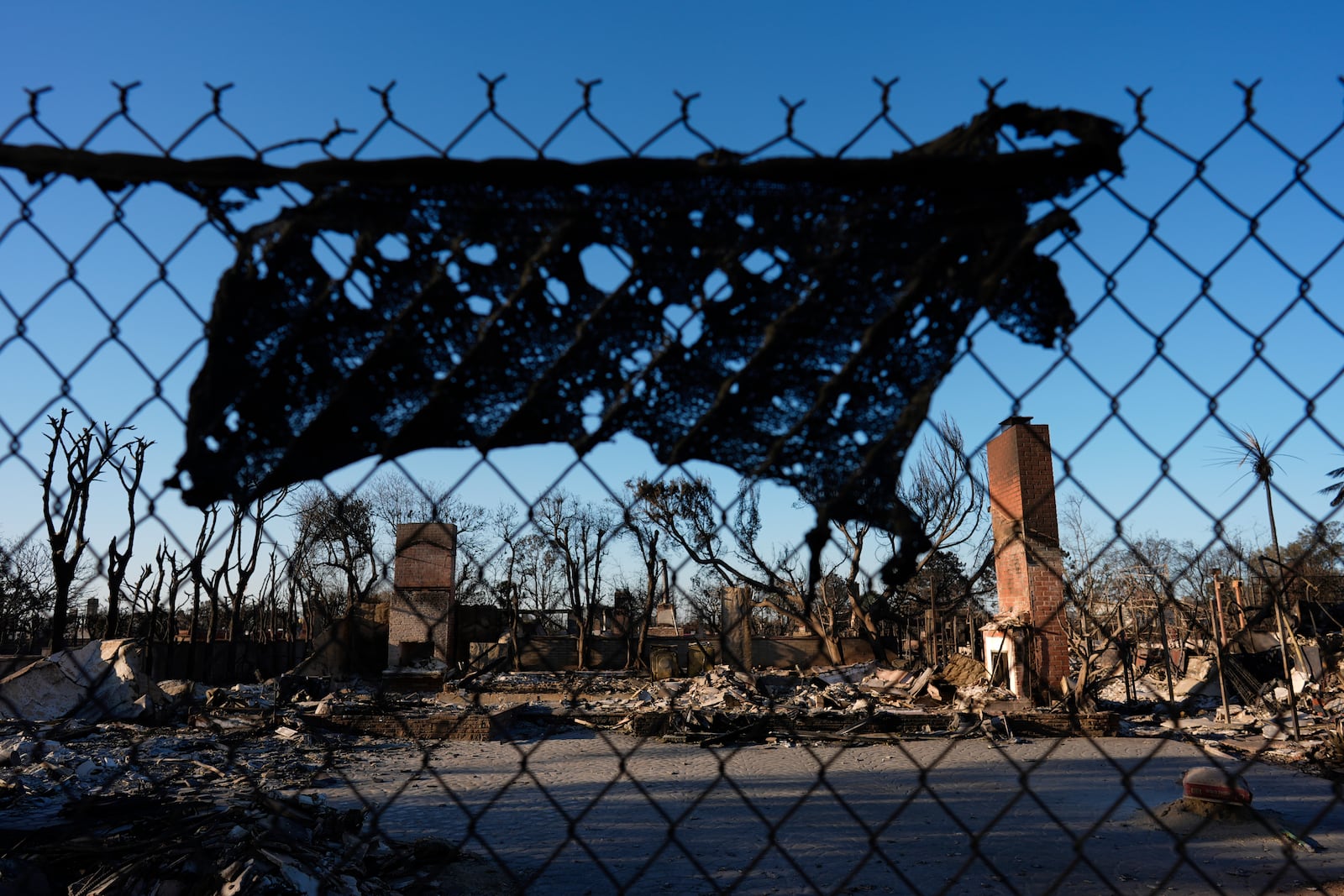 Homes destroyed by the Palisades Fire in the Pacific Palisades neighborhood of Los Angeles is seen, Wednesday, Jan. 15, 2025. (AP Photo/Carolyn Kaster)