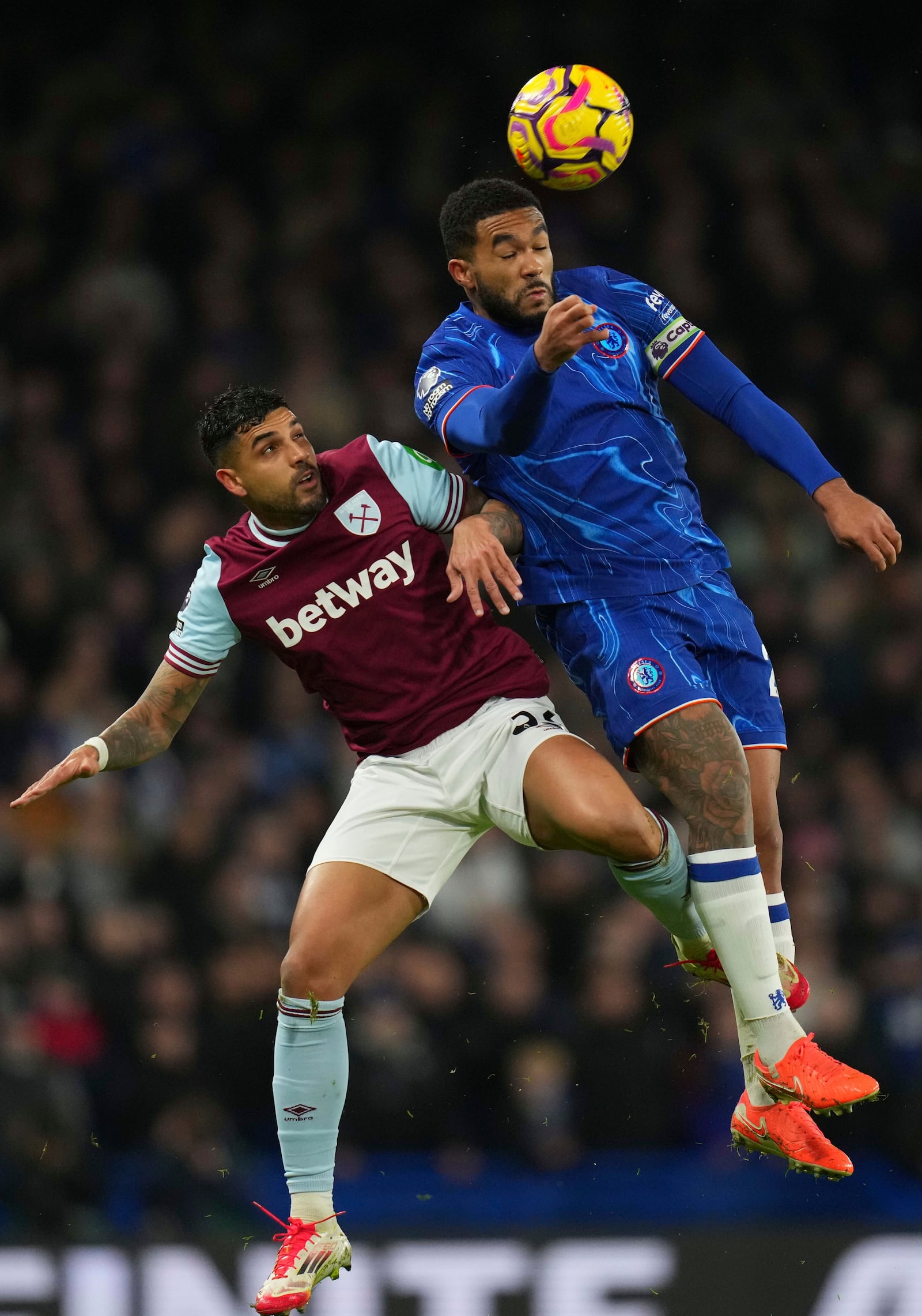 Chelsea's Reece James, top and West Ham's Emerson Palmieri challenge for the ball during the English Premier League soccer match between Chelsea and West Ham United at Stamford Bridge stadium in London, Monday, Feb. 3, 2025. (AP Photo/Kirsty Wigglesworth)