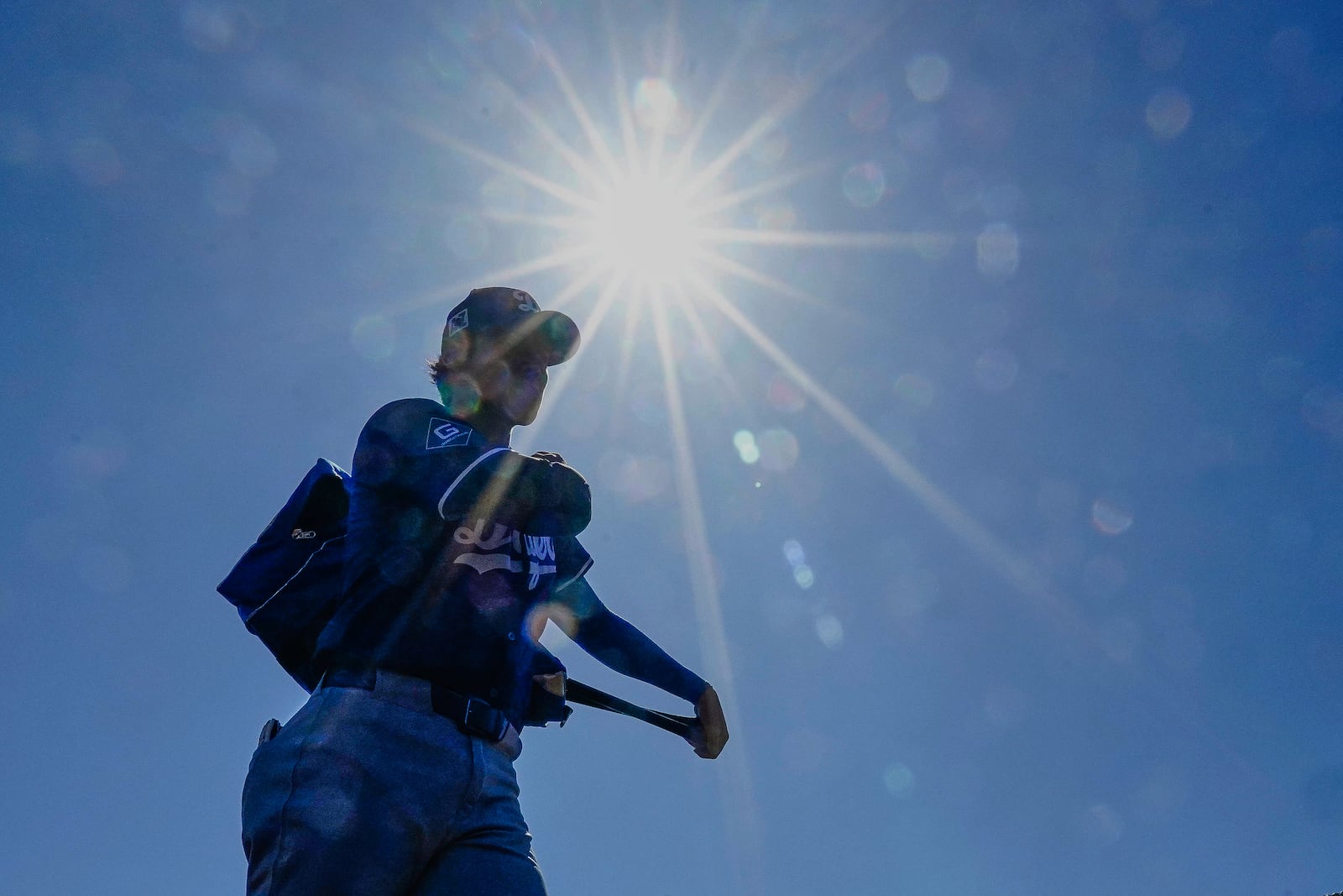 Los Angeles Dodgers two-way player Shohei Ohtani (17) makes his way into the dugout before their spring training baseball game against the Chicago White Sox, Saturday, March 8, 2025, in Phoenix. (AP Photo/Darryl Webb)