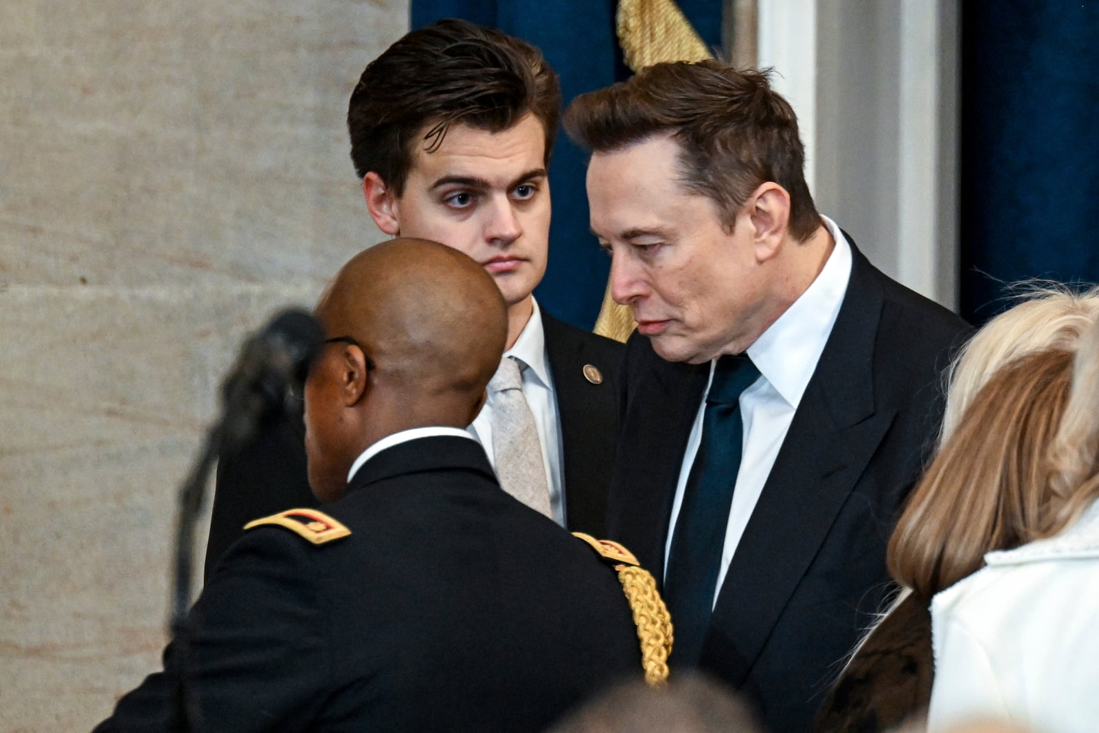 Elon Musk, right, arrives before the 60th Presidential Inauguration in the Rotunda of the U.S. Capitol in Washington, Monday, Jan. 20, 2025. (Kenny Holston/The New York Times via AP, Pool)