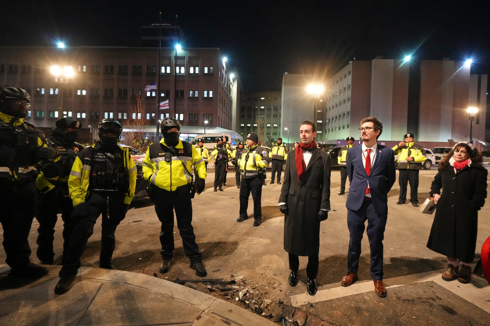 Police and media gather outside the DC Central Detention Facility, Monday, Jan. 20, 2025, in Washington. (AP Photo/Julio Cortez)