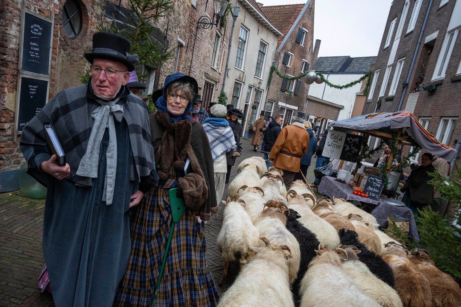 People in costumes from Charles Dickens' 19th-century English era take part in a Dickens Festival, in Deventer, Netherlands, Saturday, Dec. 14, 2024. (AP Photo/Peter Dejong)