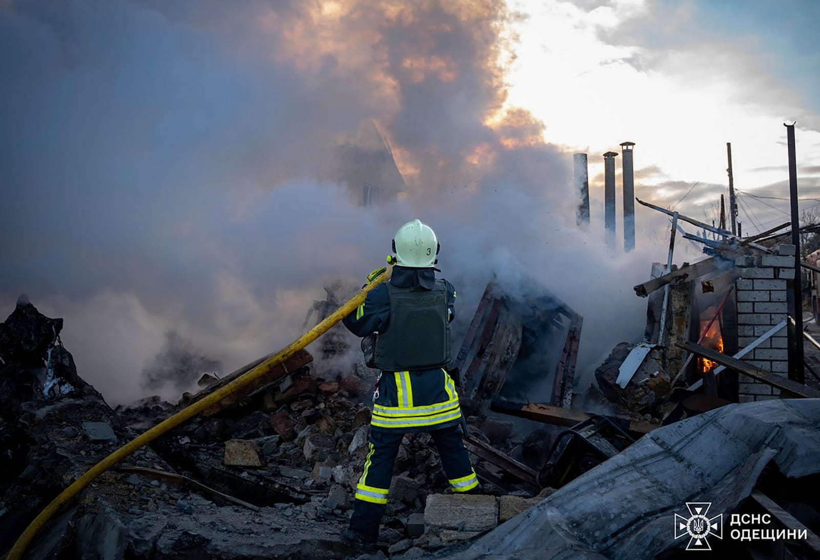 In this photo provided by the Ukrainian Emergency Service, firefighters put out the fire following a Russian rocket attack in Odesa region Ukraine, Sunday, Nov. 17, 2024. (Ukrainian Emergency Service via AP)