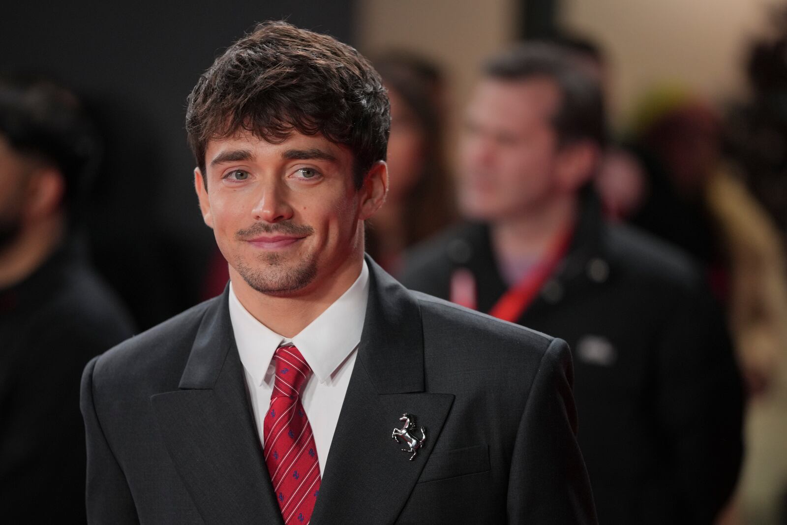 Ferrari driver Charles Leclerc of Monaco poses for cameras as he arrives to the F1 75 Live event at the O2 arena in London, Tuesday, Feb. 18, 2025. (AP Photo/Kin Cheung)